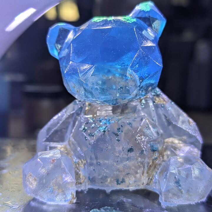 Clear faceted resin bear with blue inclusions
